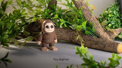 Brown Tiny Bigfoot with greenery behind