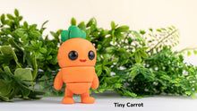 Toy carrot character with green leaves on a light background