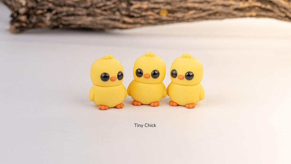 Three yellow Tiny Chick fidget toys under a wooden branch