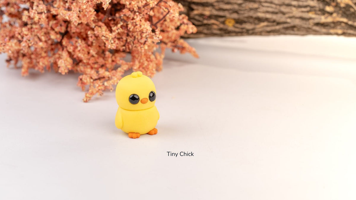Yellow Tiny Chick fidget toy with orange flowers behind