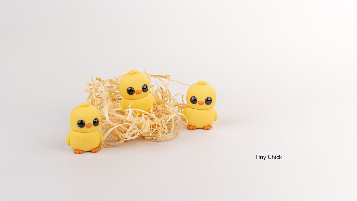 Group of yellow Tiny Chicks around a straw nest