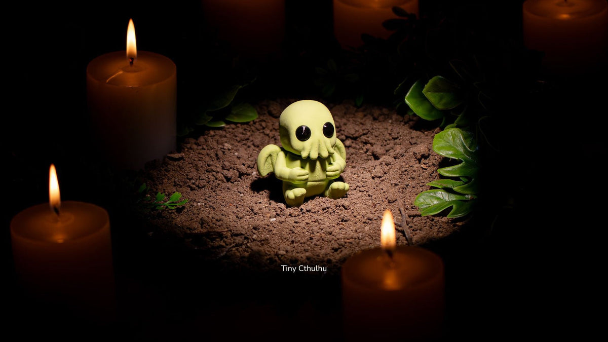 Tiny Cthulhu with tentacles surrounded by candles