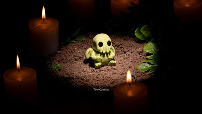 Tiny Cthulhu with tentacles surrounded by candles