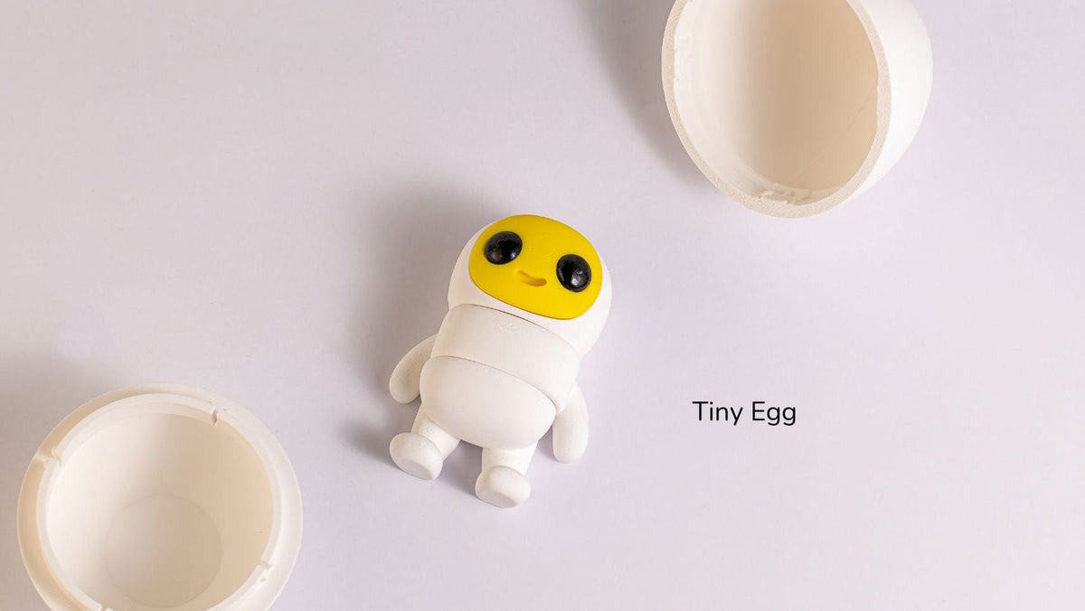 Tiny Egg character standing beside its cracked shell