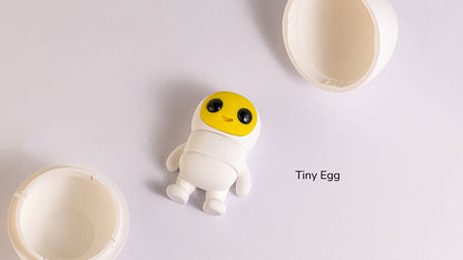 Tiny Egg character standing beside its cracked shell