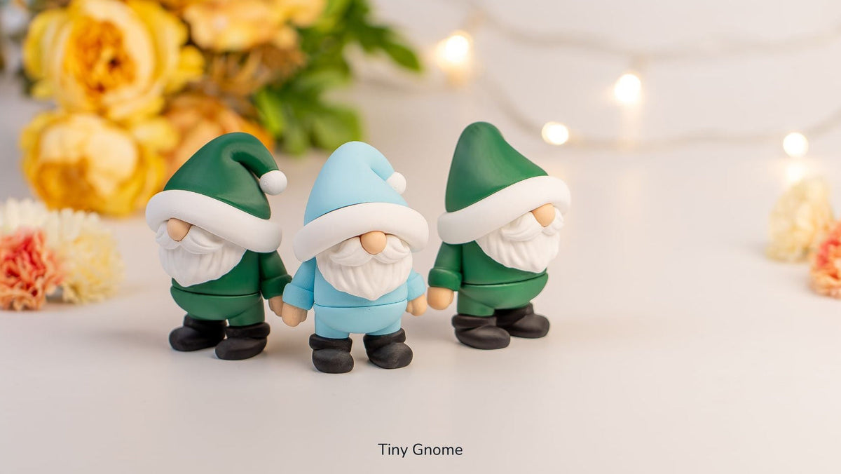 Tiny Gnomes in green and blue with fairy lights behind