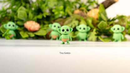 Row of green Tiny Goblins in front of greenery