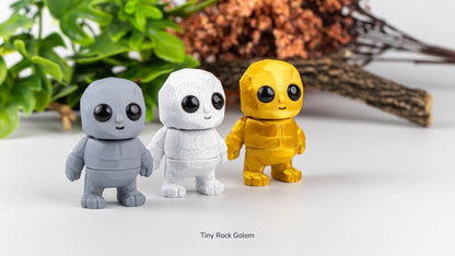 Grey, white and yellow Tiny Rock Golems in front of plants