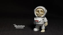 Tiny skeleton astronaut figurine on a dark background