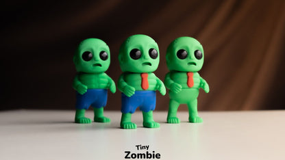 Three green Tiny Zombies in blue clothes on a dark background