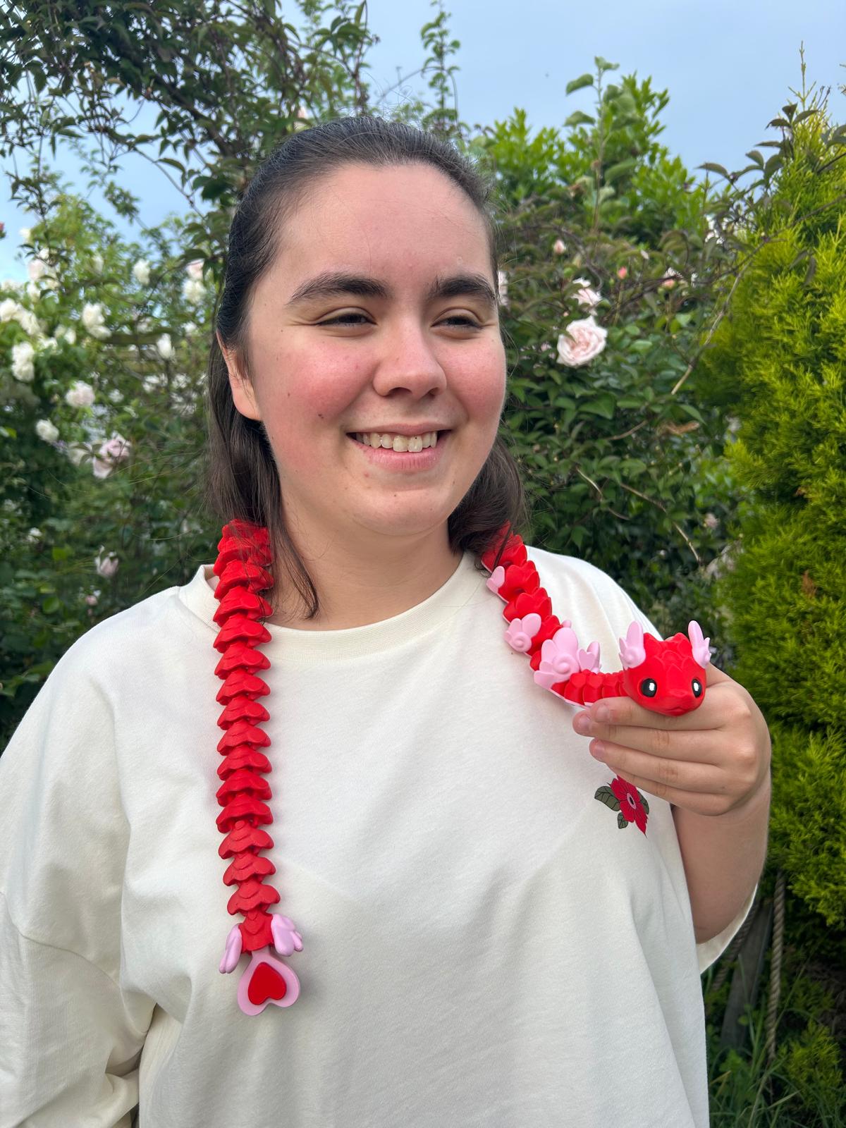 Person wearing a long red Cupid Snake around their neck
