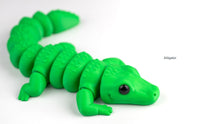 Green alligator toy on a white background