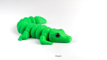 Green alligator toy on a white background