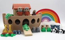 Noah's Ark toy set with animals and rainbow on a white background